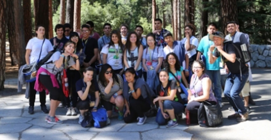 group of students in front of forest